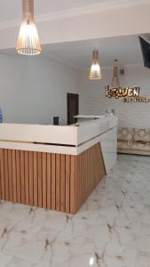 a kitchen with a white counter and two lights at Keruen Deluxe in Taraz