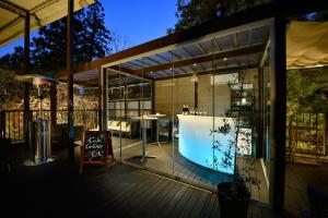 a glass house with a swimming pool on a deck at Ryokan Sumiya Kihoan in Kameoka