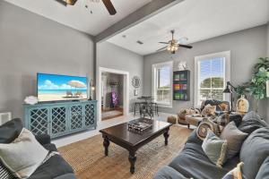 a living room with a couch and a table at The Sparkled Seahorse in Galveston