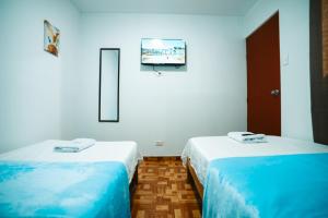 Giường trong phòng chung tại POSADA MIS 3 BENDICIONES