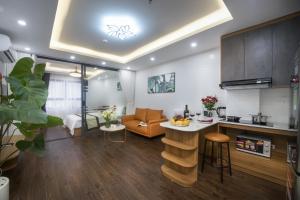 Bao Hung Hotel & Apartment - Tran Quoc Vuong في هانوي: مطبخ وغرفة معيشة مع أريكة وطاولة