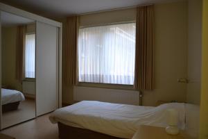 Postel nebo postele na pokoji v ubytování Lindehof Serviced Flats