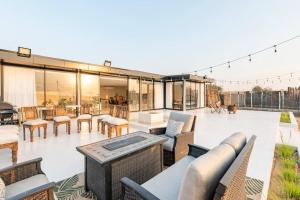 an outdoor patio with chairs and a table at Desert farm gateway W/ pool & horse in Hunaywah