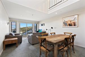 a living room with a wooden table and chairs at White Crystal 206 in Mount Hotham