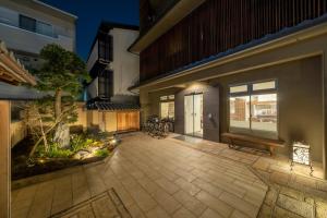a patio of a home at night at RESI STAY Jisco Hotel Kyoto Goshonishi in Kyoto