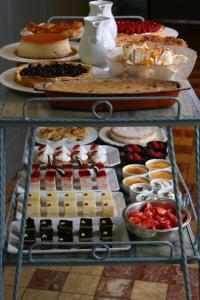 a table filled with different types of desserts and cakes at Castel Hotel 1904 in Saint-Gervais-dʼAuvergne +18 photos