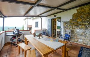 a dining room with a table and a stone wall at 2 Bedroom Beautiful Apartment In Aulla in Aulla