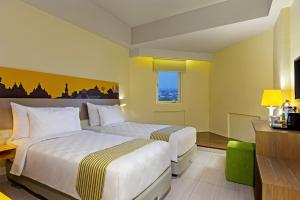 Postel nebo postele na pokoji v ubytování KHAS Malioboro Hotel + 32 fotografií