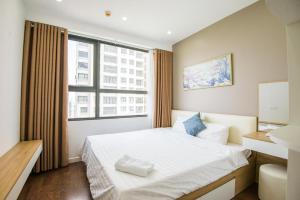 a bedroom with a bed and a large window at Linh Homestay in Hanoi