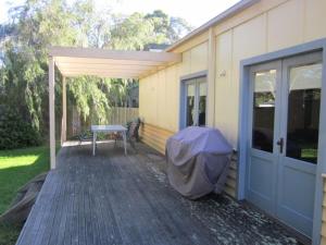 a patio with a table and a tent on a house at 14 McLardy Courtes in Cowes