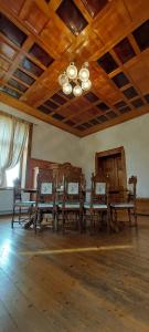 a room with wooden chairs and a ceiling with a chandelier at ŠulcBurg in Cetenov