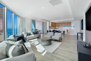 a living room with a couch and a table at Hilton Five Star Panoramic Oceanview Sub-Penthouse in Gold Coast