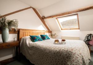 a bedroom with a bed with a plate of food on it at The Tollant in Rhayader