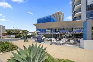 a building with a table and chairs in front of it at Seacrest, Surfers Beach Front 15A in Gold Coast