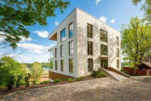 a house with a slide in front of it at Oru Villa, LUXURY 3 BR APARTMENT, SAUNA, BEACH in Viljandi