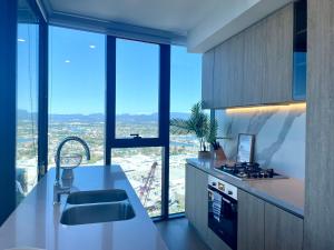 a kitchen with a counter and a large window at Luxury 2 bedrm apartment in Broadbeach- Be a Star in Tower One of the casino 2 bedroom apartment 334F in Gold Coast