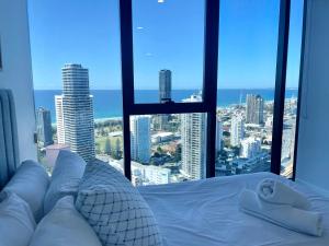 a bedroom with a bed with a view of the city at Luxury 2 bedrm apartment in Broadbeach- Be a Star in Tower One of the casino 2 bedroom apartment 334F in Gold Coast