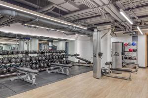 a gym with rows of dumbbells and weights at Midtown East 2br w gym wd nr Grand Central NYC-1146 in New York
