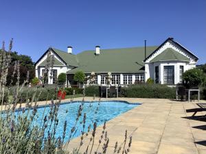 a house with a swimming pool in front of a house at Kingston Farm in Bathurst