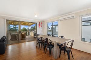 a dining room with a table and chairs at Seven on Ophir in Ventnor +7 photos