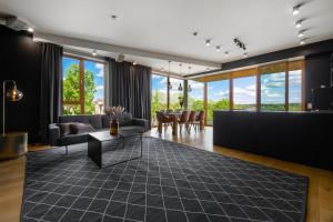 a living room with a couch and a table at Oru Villa - Luxury 1, 2 or 3 bedroom apartment in Viljandi