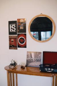 a table with a mirror and posters on the wall at D Black Houze Banyuwangi in Banyuwangi