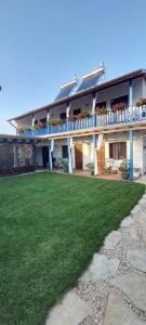 a large house with a lawn in front of it at Casa IBIS in Mahmudia