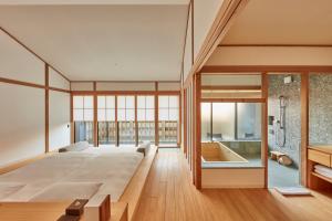a master bedroom with a large bed and a tub at Azumi Setoda in Onomichi