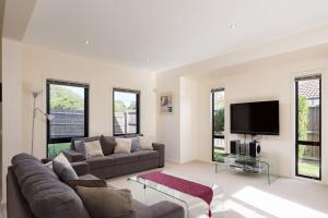 a living room with a couch and a flat screen tv at Getaway on Church Free Wifi - Stay 4 Pay 3 - Promo code Getaway in Cowes