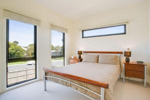 a bedroom with a bed and a large window at Getaway on Church Free Wifi - Stay 4 Pay 3 - Promo code Getaway in Cowes