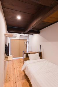 Postel nebo postele na pokoji v ubytování FARMSTAY miyuki-street "Goen"
