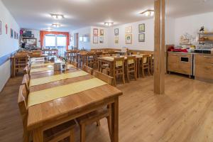 a restaurant with wooden tables and wooden chairs at Panorama B&B in Ptuj