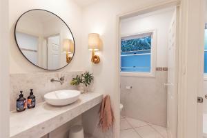 a bathroom with a sink and a mirror at Celeste, 26 Bonito Street - Tranquil, Stylish & Pet friendly in Corlette +37 photos