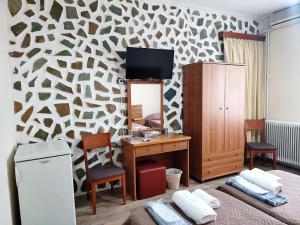 a room with a desk and a tv on a wall at ASTY in Mytilini