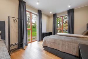a bedroom with a bed and a window with a view at Oru Villa - Luxury 3 bedroom apartment in Viljandi