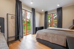 a bedroom with a bed and a window with a view at Oru Villa - Luxury 1, 2 or 3 bedroom apartment in Viljandi
