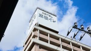 a tall building with a sign on top of it at Toyoko Inn Tokyo Tozai-sen Nishi-kasai in Tokyo