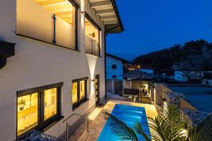 a villa with a swimming pool at night at Riedbach-Lodge in Viechtach