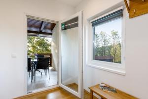 a room with windows and a dining room with a table at Apartman Medved in Slunj