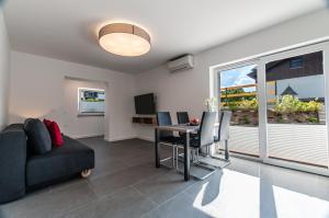 a living room with a couch and a table at Apartments Ursus in Bled