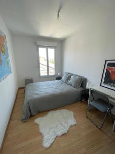 Säng eller sängar i ett rum på Appartement 2 chambres Gare Sud