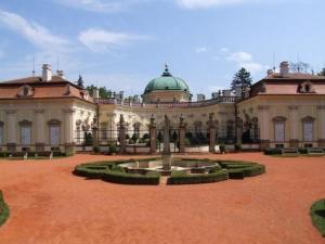 a large building with a fountain in a courtyard at Chata CONDI in Buchlovice