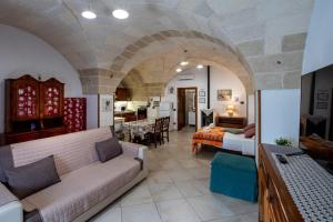 a living room with two couches and a room with a bedroom at La Dimora di Sofia in Giuggianello