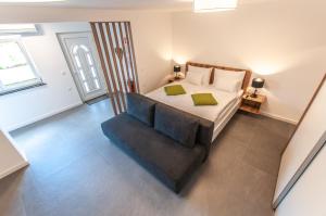 a bedroom with a large bed and a chair at Apartments Ursus in Bled