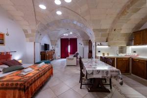 a large room with two beds and a table in it at La Dimora di Sofia in Giuggianello