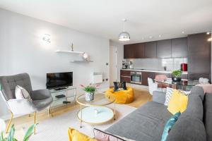 ein Wohnzimmer mit einem Sofa und einem Tisch in der Unterkunft Stunning Apartment with Underground parking! in London