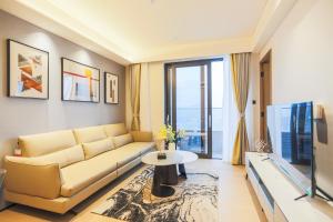 a living room with a couch and a table at Canopy Executive Apartments - Shenzhen Futian Center in Shenzhen