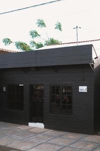 a black building with a sign on it at D Black Houze Banyuwangi in Banyuwangi +20 photos