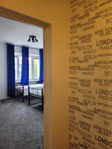 a room with a wall that has writing on it at Miastkovo in Poznań