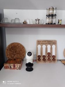 a shelf with a bunch of donuts and a box at Уютна къща in Sliven